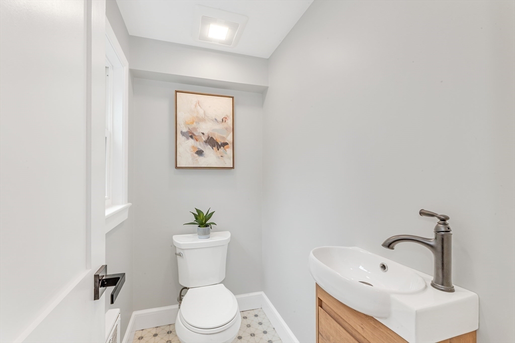 26 Crehore Road Boston, MA 02467 - Photo 8 of 33 a bathroom with a toilet a sink and mirror