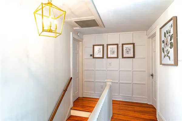 a view of hallway with a large window and mirror