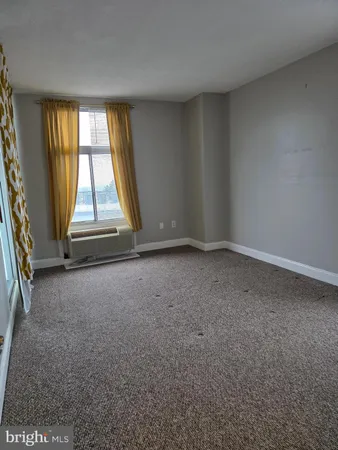 an empty room with a empty space and windows