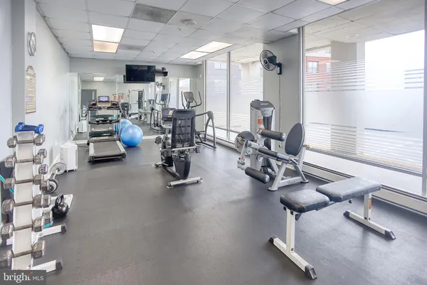 a room with gym equipment and a large window