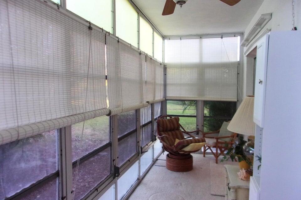 1225 Northwest 21st Street, Unit 3506 Stuart, FL 34994 - Photo 19 of 25 a view of a chairs and table in the balcony