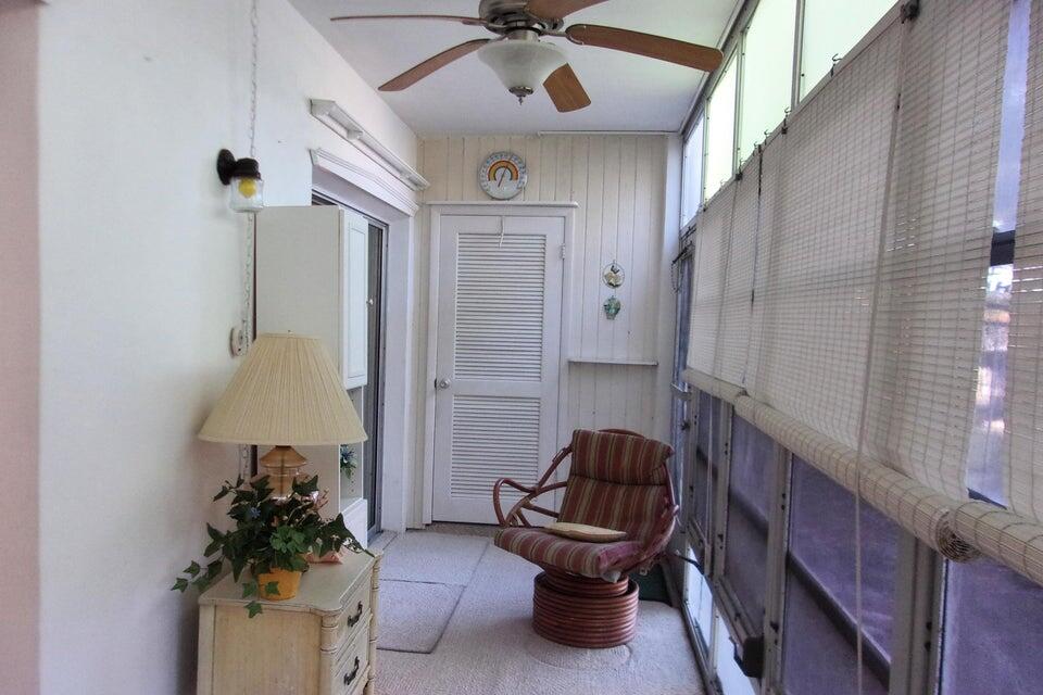 1225 Northwest 21st Street, Unit 3506 Stuart, FL 34994 - Photo 20 of 25 a living room with furniture and a potted plant