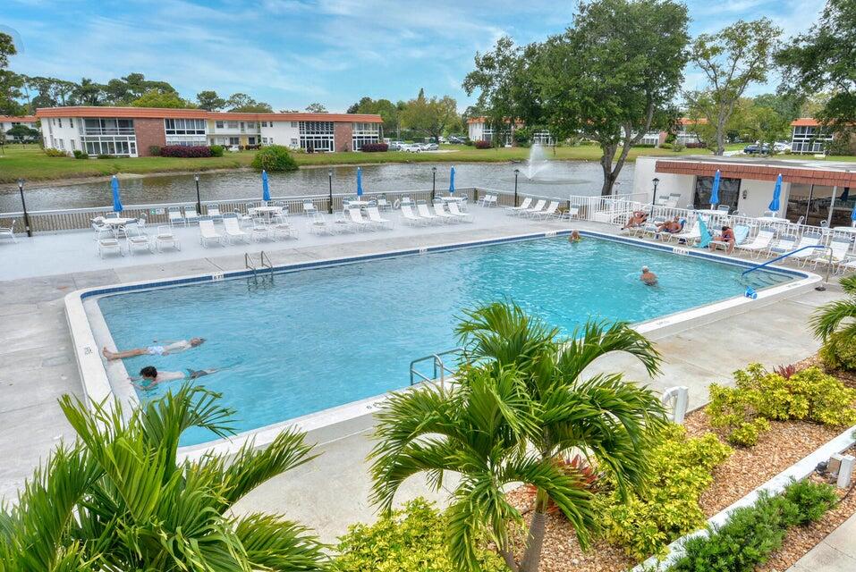 1225 Northwest 21st Street, Unit 3506 Stuart, FL 34994 - Photo 22 of 25 a view of a swimming pool with a patio