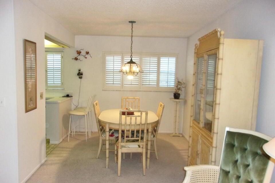 1225 Northwest 21st Street, Unit 3506 Stuart, FL 34994 - Photo 5 of 25 a dining room with furniture and window