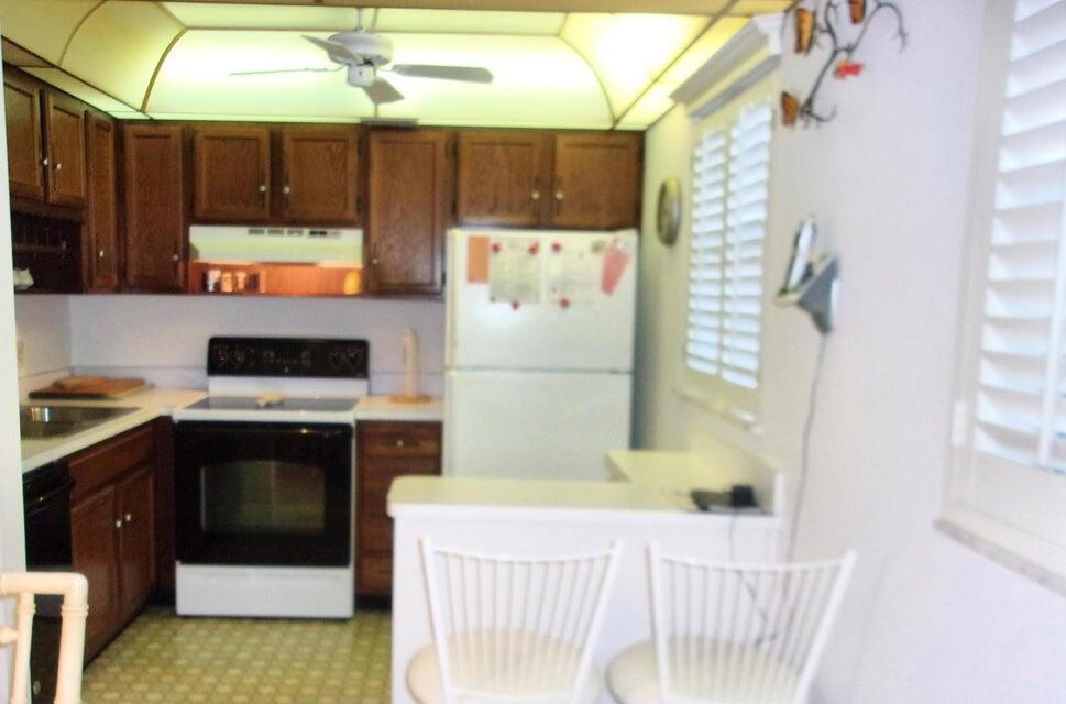1225 Northwest 21st Street, Unit 3506 Stuart, FL 34994 - Photo 6 of 25 a kitchen with a refrigerator and a stove