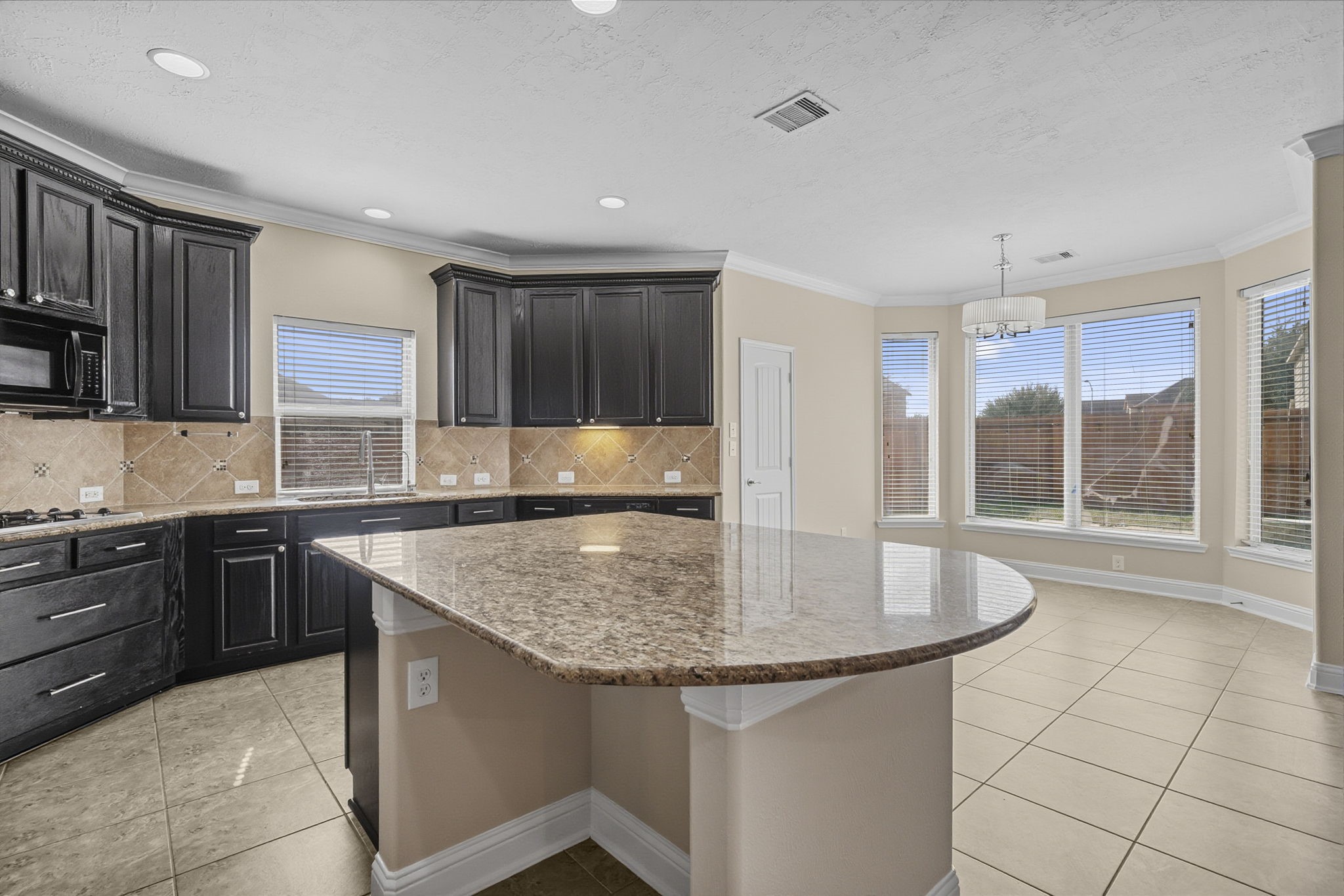 8507 Clarkman Ridge Lane Cypress, TX 77433 - Photo 11 of 48 a kitchen with kitchen island granite countertop a sink cabinets and window