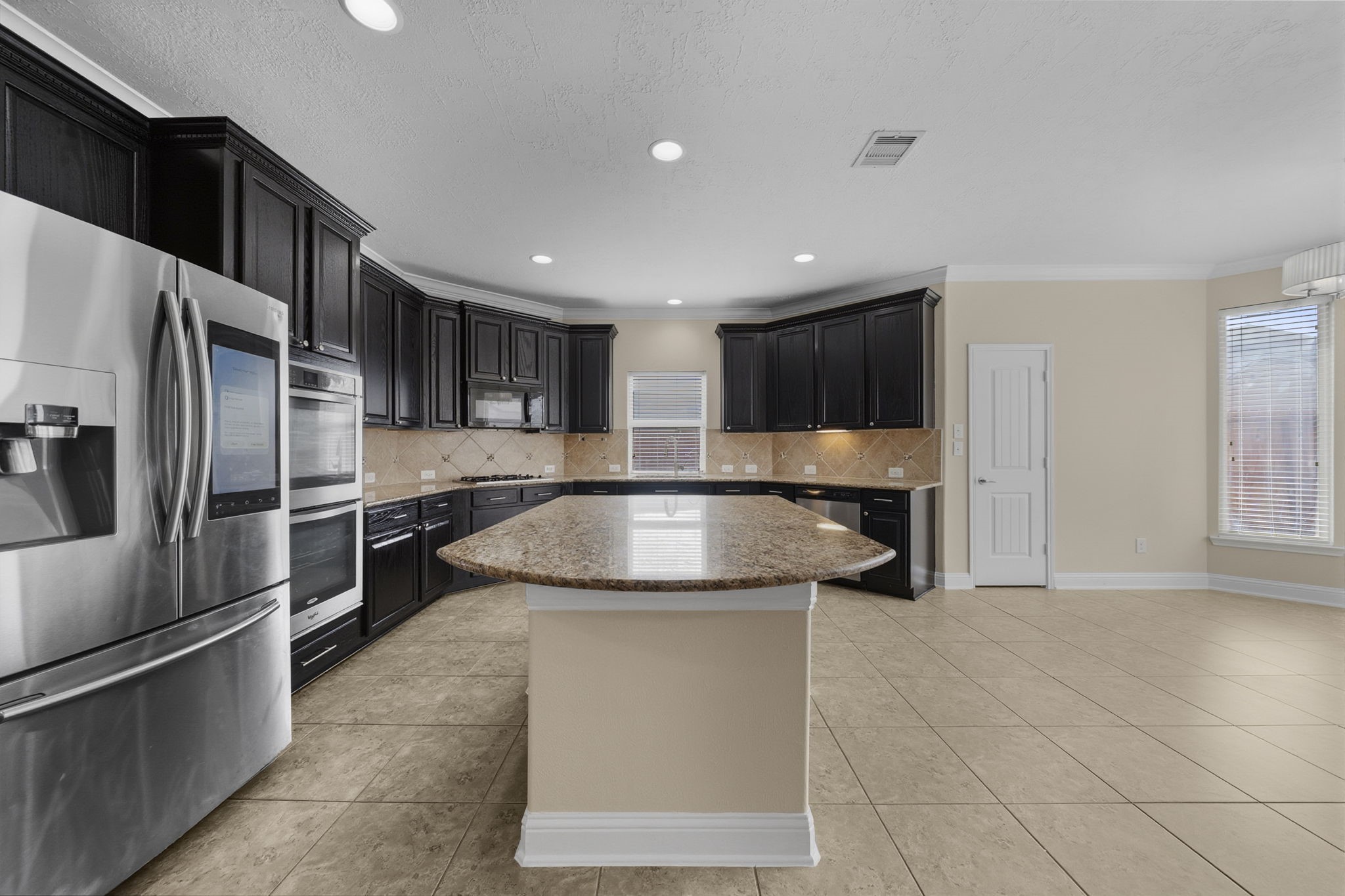 8507 Clarkman Ridge Lane Cypress, TX 77433 - Photo 12 of 48 a kitchen with stainless steel appliances granite countertop a sink and a refrigerator
