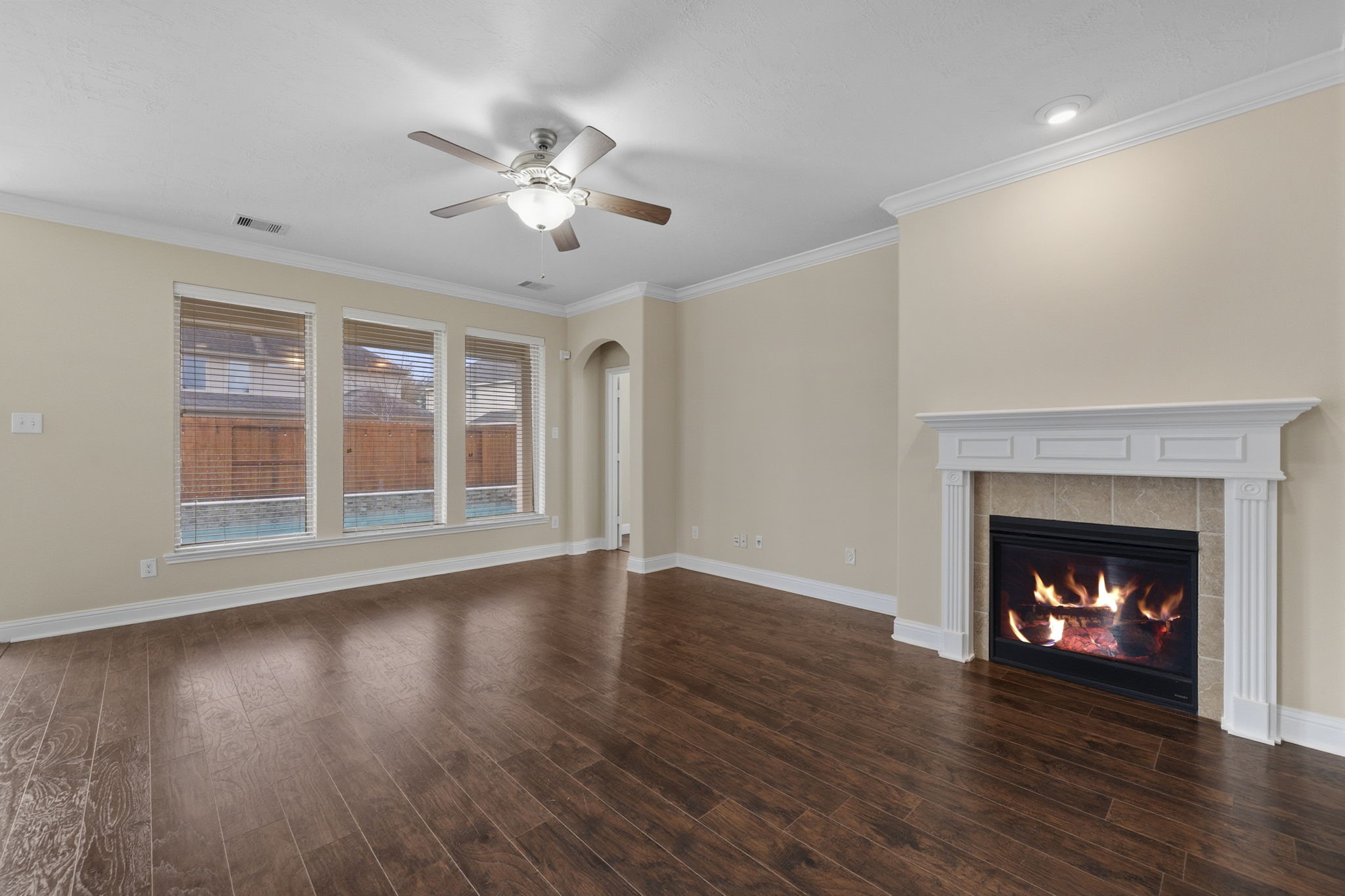 8507 Clarkman Ridge Lane Cypress, TX 77433 - Photo 19 of 48 a view of an empty room with wooden floor fireplace and a window