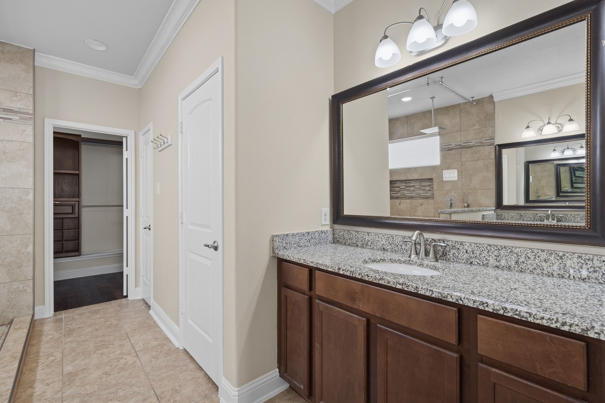 8507 Clarkman Ridge Lane Cypress, TX 77433 - Photo 26 of 48 a bathroom with a granite countertop sink and a mirror