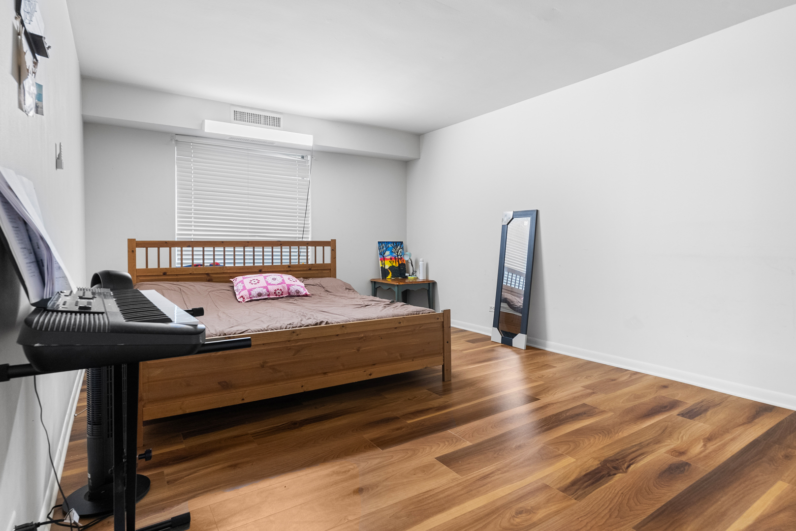 1405 East Central Road, Unit 110B Arlington Heights, IL 60005 - Photo 14 of 24 a bedroom with a bed and wooden floor