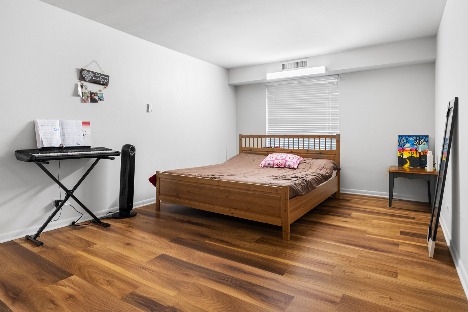 1405 East Central Road, Unit 110B Arlington Heights, IL 60005 - Photo 15 of 24 a bedroom with a bed a dresser and book shelf