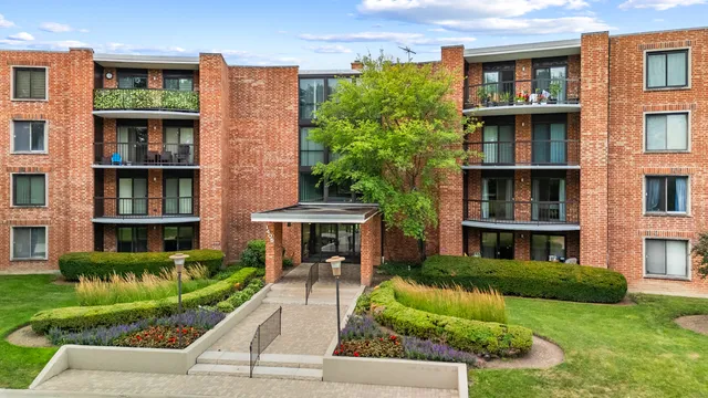 a front view of a residential apartment building with a yard