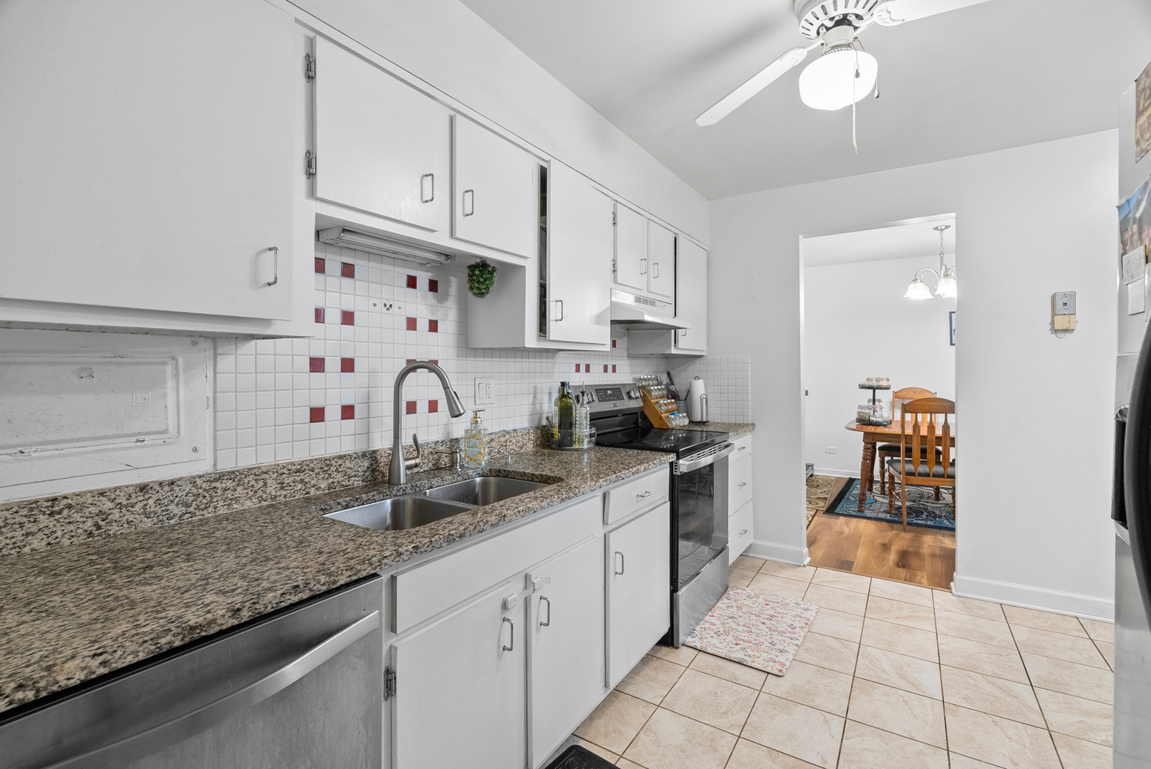 1405 East Central Road, Unit 110B Arlington Heights, IL 60005 - Photo 4 of 24 a kitchen with white cabinets and sink
