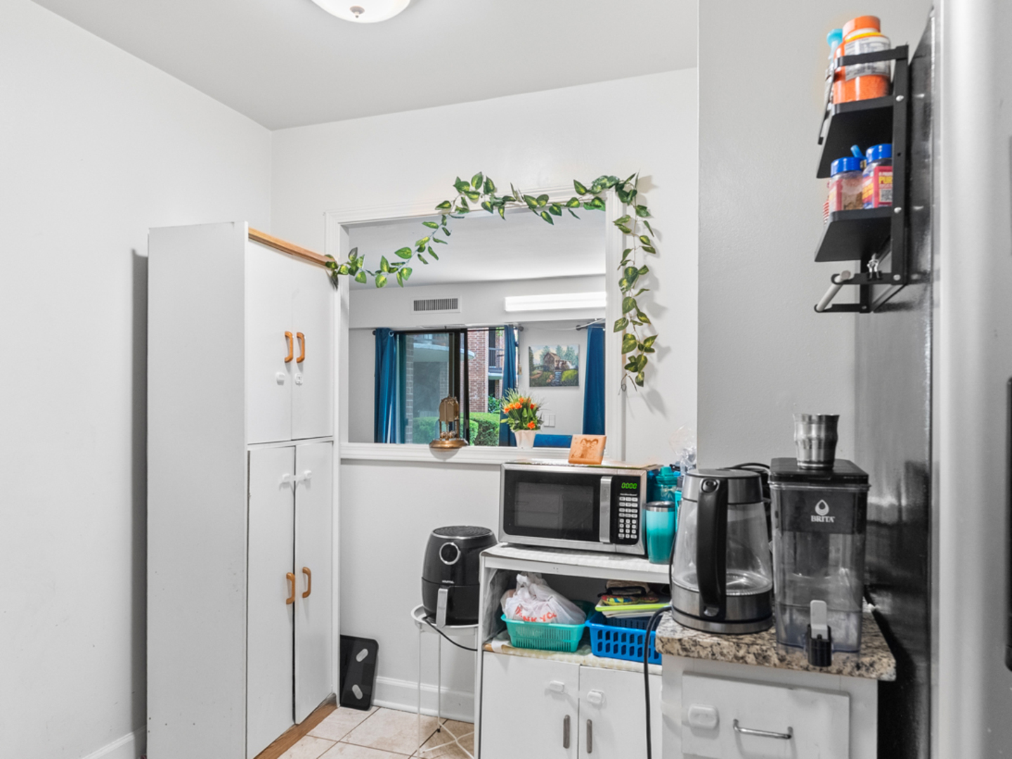 1405 East Central Road, Unit 110B Arlington Heights, IL 60005 - Photo 5 of 24 a work place with refrigerator and washer