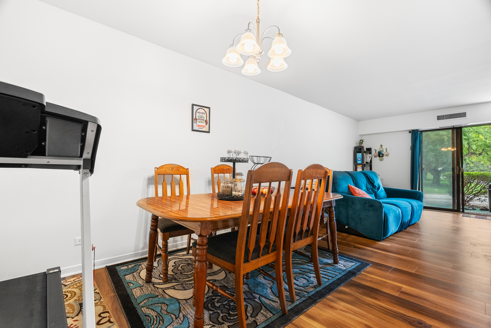 1405 East Central Road, Unit 110B Arlington Heights, IL 60005 - Photo 8 of 24 a view of a dining room with furniture and wooden floor