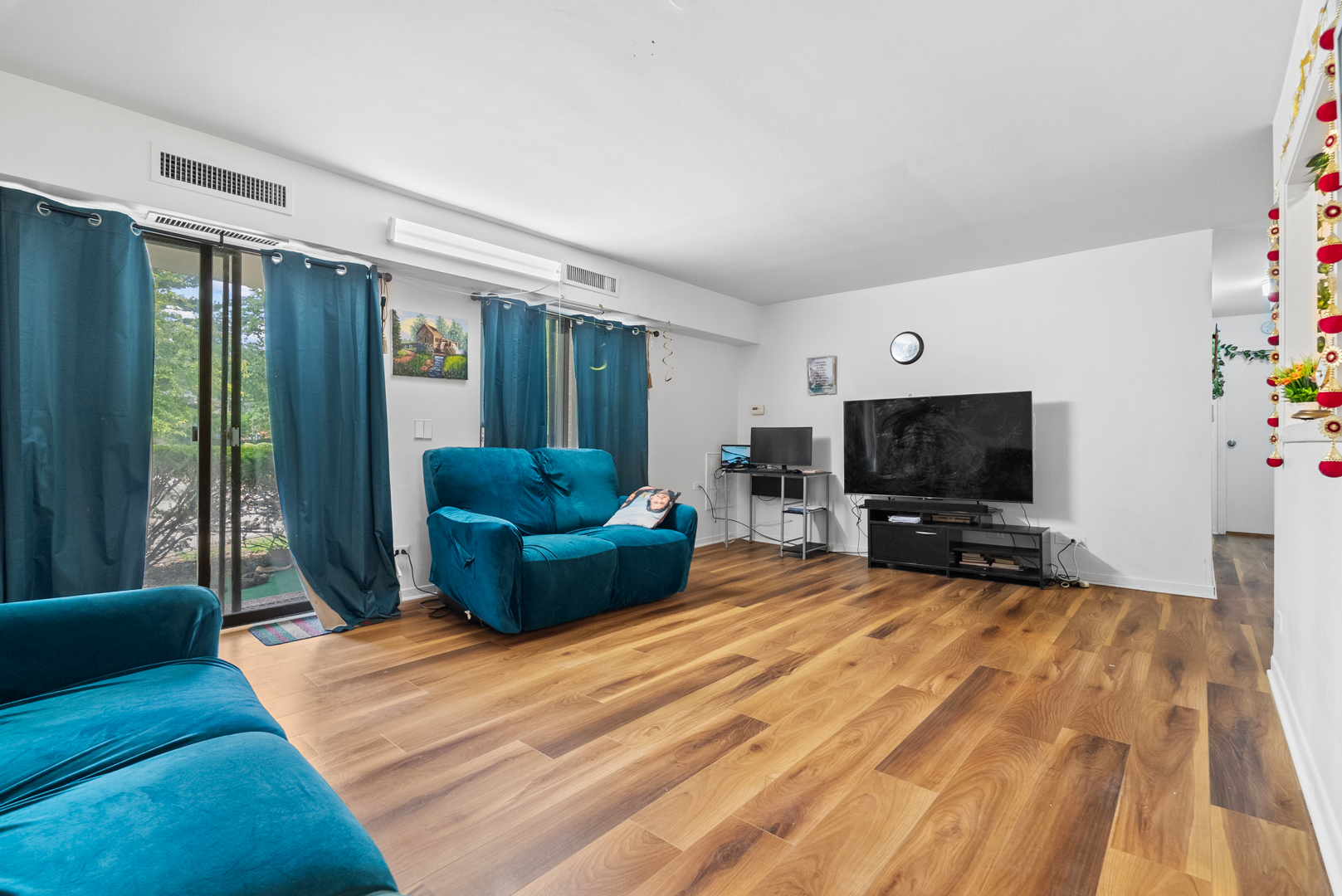1405 East Central Road, Unit 110B Arlington Heights, IL 60005 - Photo 9 of 24 a living room with furniture a flat screen tv and a fireplace