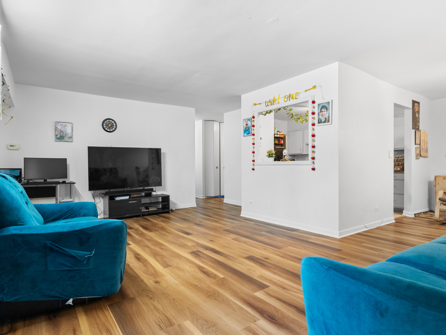 1405 East Central Road, Unit 110B Arlington Heights, IL 60005 - Photo 10 of 24 a living room with furniture and a flat screen tv