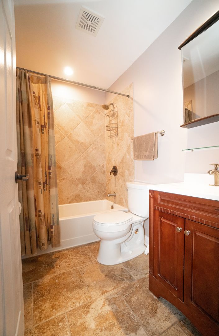 8233 Ripple Ridge, Unit 8233 Darien, IL 60561 - Photo 18 of 18 a bathroom with a toilet sink and shower