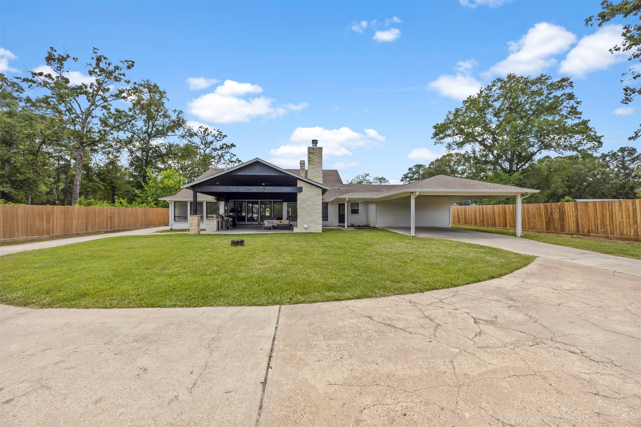 18022 Rogers Road New Waverly, TX 77358 - Photo 9 of 49 Back View w/ Porte Cochere and Covered Porch