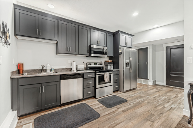 1526 South 500 West Mapleton, UT 84664 - Photo 28 of 54 Kitchen featuring stainless steel appliances, light wood-style flooring, recessed lighting, and light stone counters