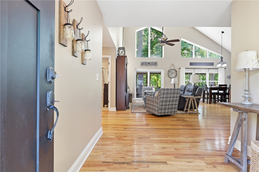 1110 Sunset Lane Anderson, SC 29626 - Photo 3 of 38 Hardwood floors guide you through this inviting open-concept living space, illuminated by abundant natural light and soaring ceilings.