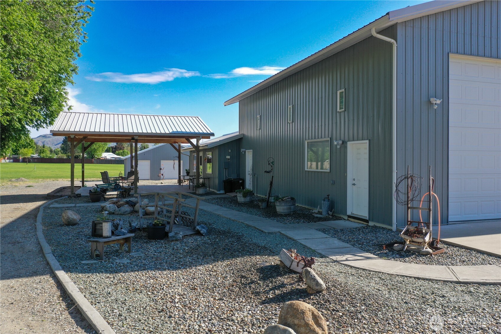 46 Shumway Road Omak, WA 98841 - Photo 31 of 40 a view of a house with backyard porch and sitting area