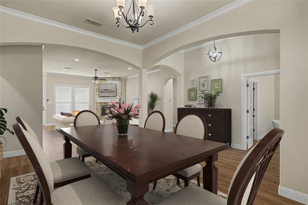143 Wrigley Drive Springtown, TX 76082 - Photo 4 of 40 Virtually Staged - Formal dining area featuring wood-finish flooring, recessed lighting, and an ornate chandelier