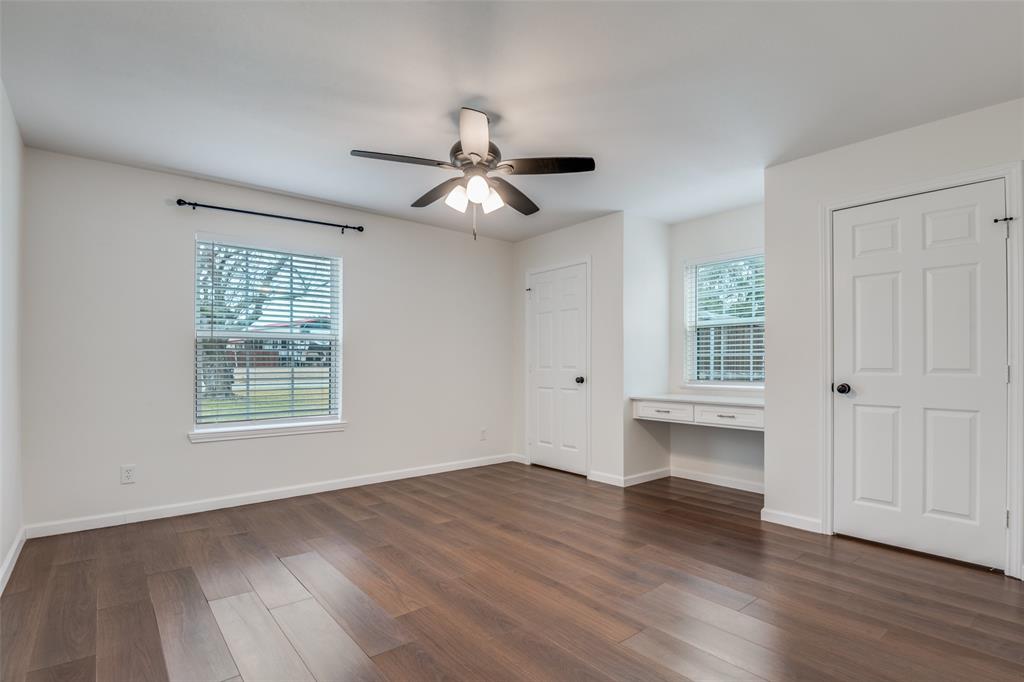 1055 Wright Street Terrell, TX 75160 - Photo 11 of 20 a view of an empty room with wooden floor and a window