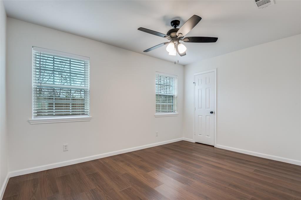 1055 Wright Street Terrell, TX 75160 - Photo 12 of 20 a view of an empty room with wooden floor and a window