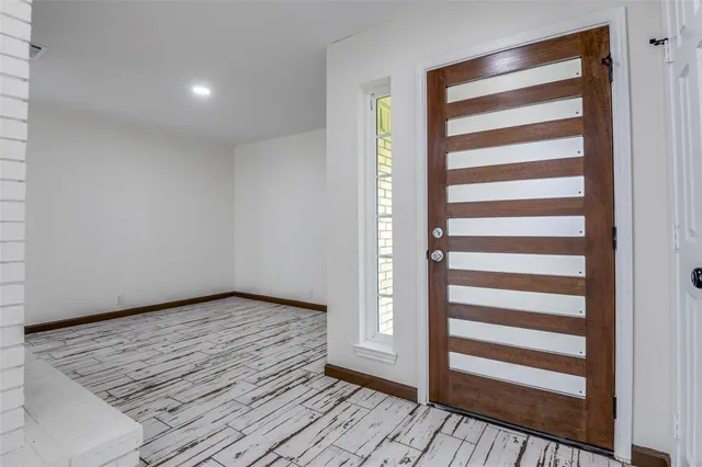 a view of wooden floor and windows in a room