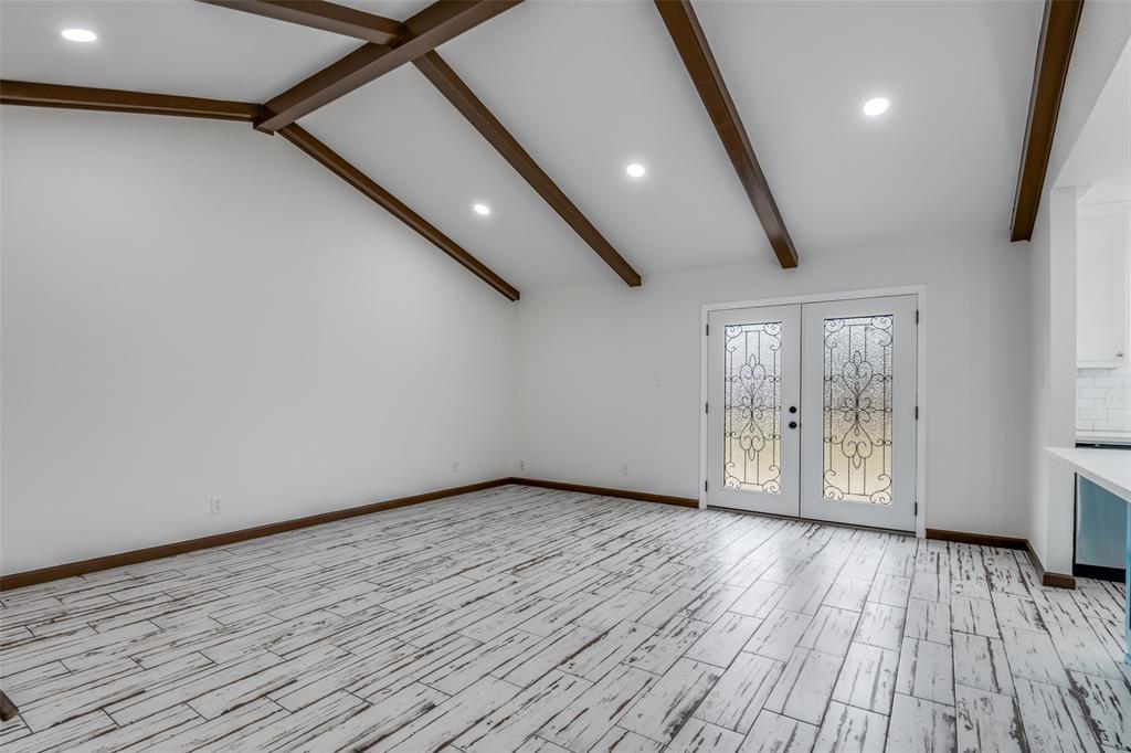 1055 Wright Street Terrell, TX 75160 - Photo 6 of 20 a view of an empty room with wooden floor and a window