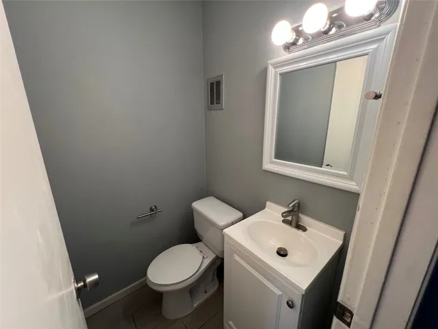a white toilet sitting next to a bathroom sink