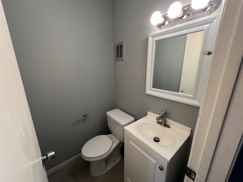 5808 Wellington Drive, Unit 4 Austin, TX 78723 - Photo 11 of 12 a white toilet sitting next to a bathroom sink