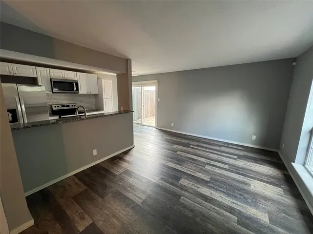 a kitchen with stainless steel appliances a refrigerator and a stove top oven