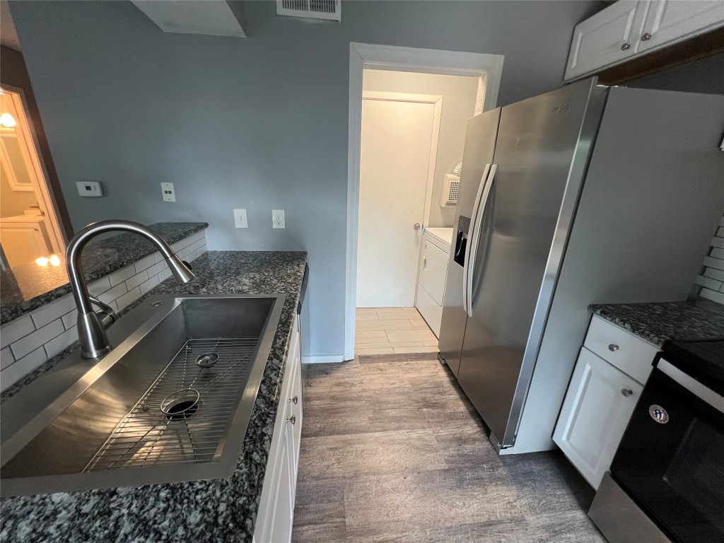 5808 Wellington Drive, Unit 4 Austin, TX 78723 - Photo 5 of 12 a kitchen with granite countertop a refrigerator and a sink