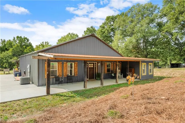 a view of a house with a backyard porch and sitting area