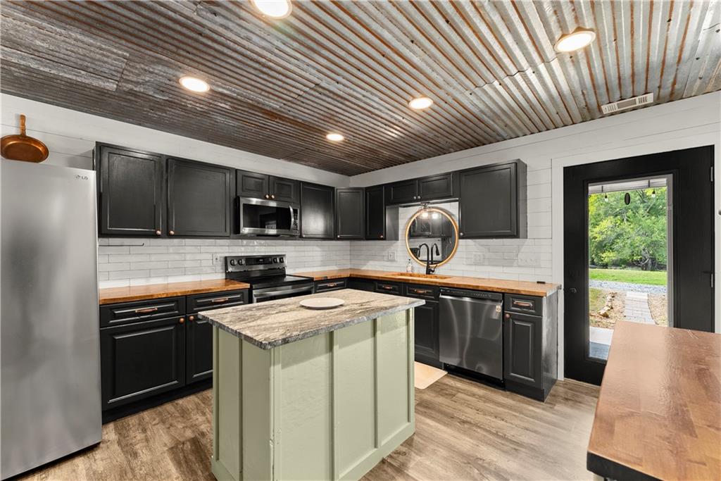 455 Cliff Nelson Road Taylorsville, GA 30178 - Photo 14 of 42 a kitchen that has a sink stainless steel appliances and cabinets