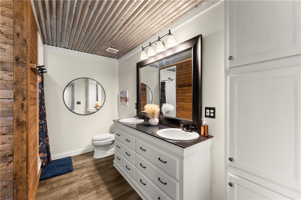 455 Cliff Nelson Road Taylorsville, GA 30178 - Photo 19 of 42 a bathroom with a mirror and a sink