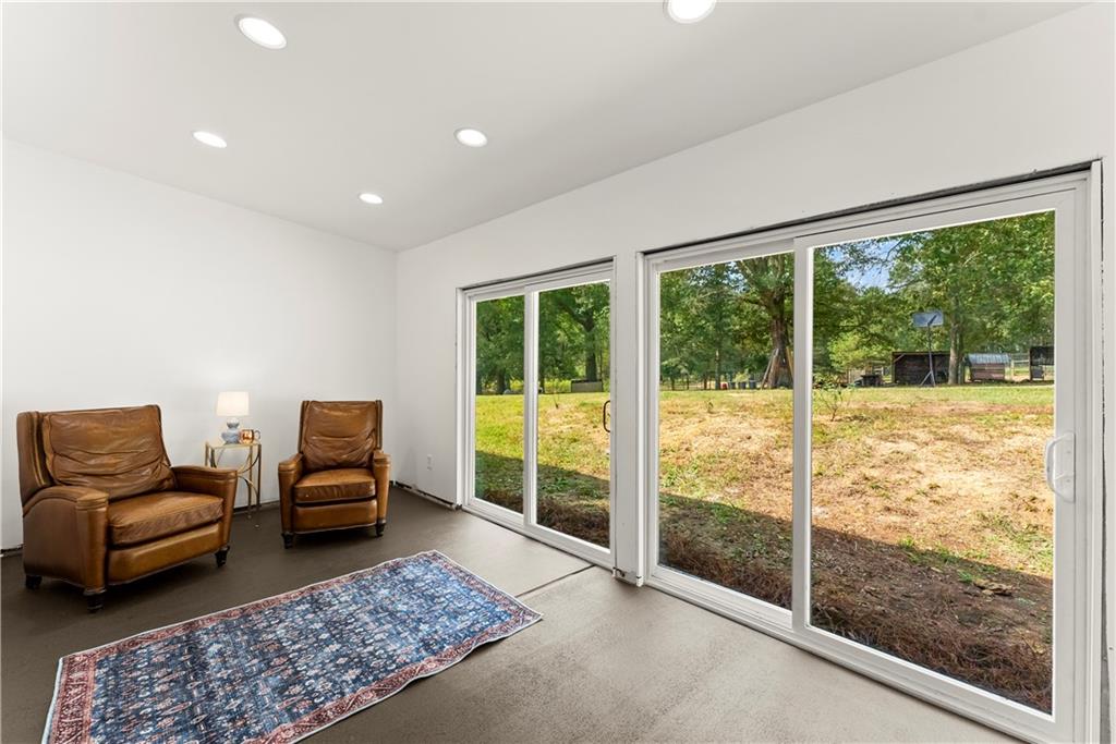 455 Cliff Nelson Road Taylorsville, GA 30178 - Photo 10 of 42 a living room with furniture and a floor to ceiling window