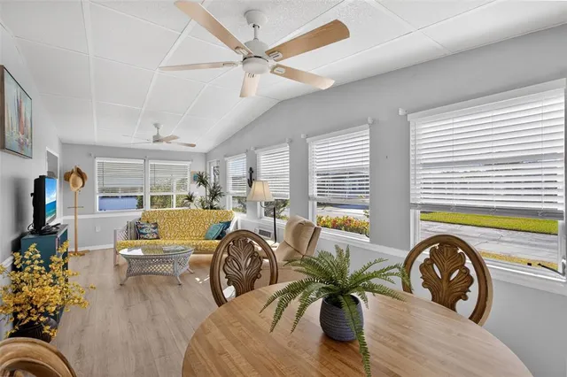 a bedroom with a bed and dresser with wooden floor