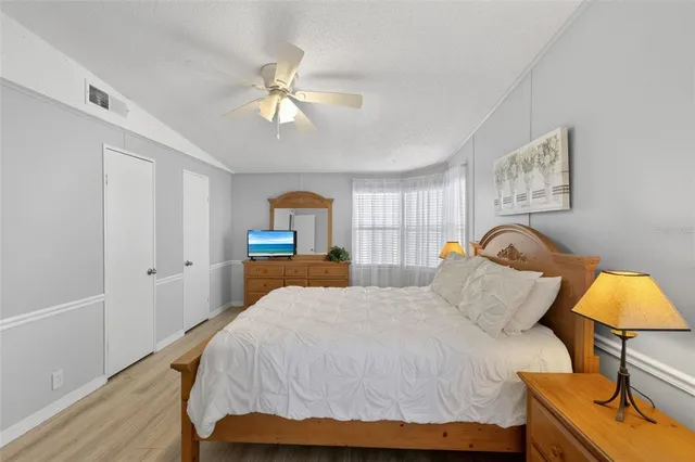 a bedroom with a bed and a chandelier