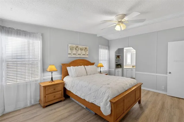 a bedroom with a bed and a painting on the wall