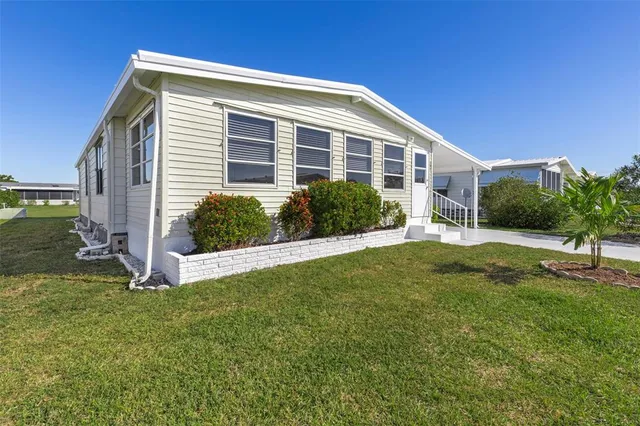 a view of a patio with couches table and chairs under an umbrella with a barbeque
