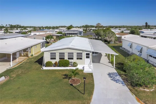 an aerial view of a house with a big yard