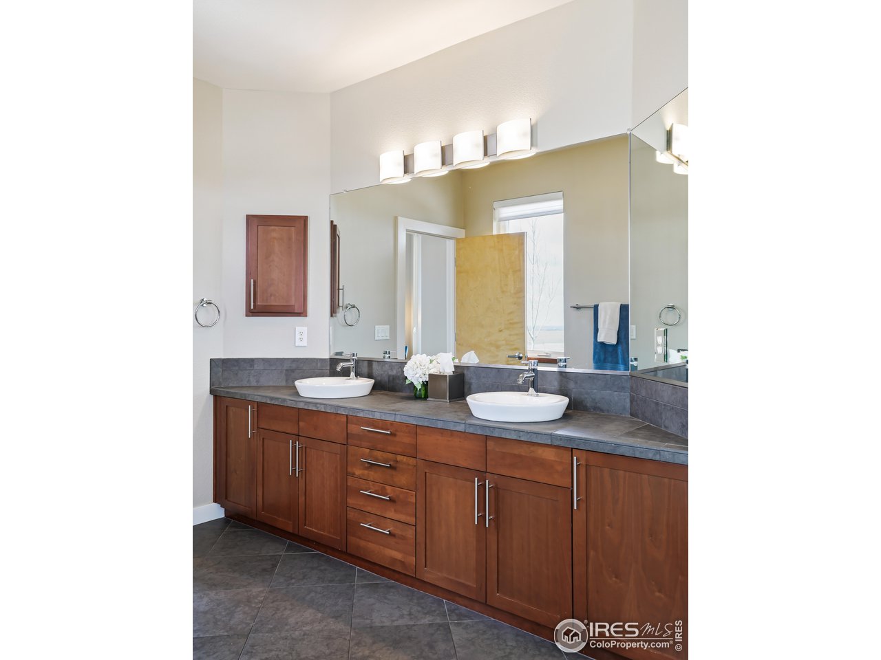 5263 Denver Street Boulder, CO 80304 - Photo 19 of 40 a bathroom with a double vanity sink and a mirror