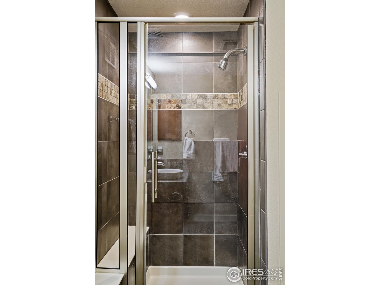 5263 Denver Street Boulder, CO 80304 - Photo 30 of 40 a bathroom with a glass shower door