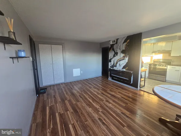 a view of empty room with wooden floor