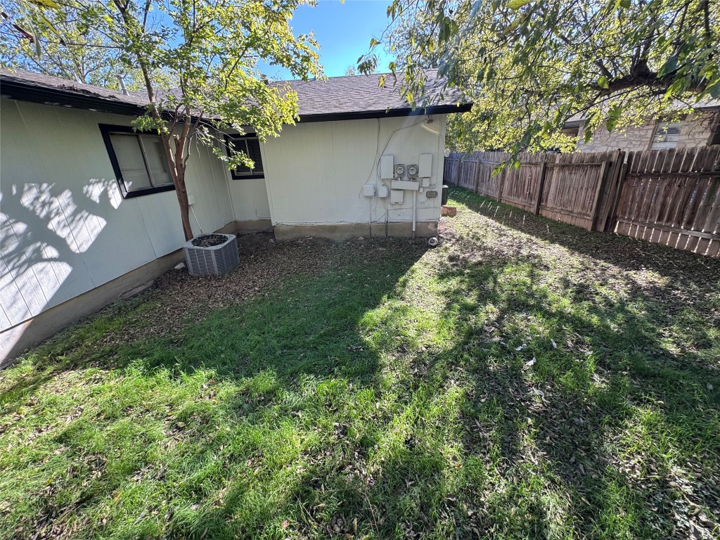 5202 Bogey Court, Unit A Austin, TX 78744 - Photo 12 of 15 a backyard of a house with table and chairs