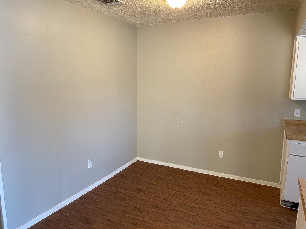 5202 Bogey Court, Unit A Austin, TX 78744 - Photo 4 of 15 a view of an empty room with wooden floor