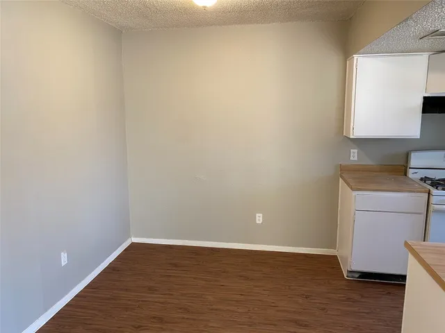 a view of a room with wooden floor and a window
